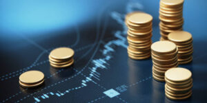 Coin stacks sitting on blue financial graph background. Horizontal composition with selective focus and copy space. Finance concept.